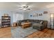Spacious living room with a comfortable sectional sofa, wood-look floors, and good natural light at 8401 N 55Th Ave, Glendale, AZ 85302