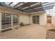 A covered patio with sliding glass doors, rock landscaping and access to the home's interior offers outdoor living at 8401 N 55Th Ave, Glendale, AZ 85302