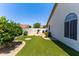 Landscaped backyard with synthetic grass, a built-in fireplace, and desert foliage at 9032 E Larkspur Dr, Scottsdale, AZ 85260