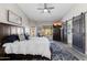 Bedroom with a large bed, sliding barn doors, TV, and view to the outdoor area at 9032 E Larkspur Dr, Scottsdale, AZ 85260