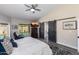Bright bedroom with a ceiling fan, TV, and view to the outdoor area at 9032 E Larkspur Dr, Scottsdale, AZ 85260