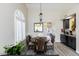 Cozy dining area with modern lighting, breakfast bar, and ample natural light at 9032 E Larkspur Dr, Scottsdale, AZ 85260