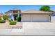 Charming home featuring a spacious two-car garage and well-maintained front yard landscaping at 9032 E Larkspur Dr, Scottsdale, AZ 85260