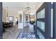 Welcoming foyer with high ceilings, modern chandelier, and open view to the dining and living spaces at 9032 E Larkspur Dr, Scottsdale, AZ 85260