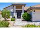 Inviting front entrance with a stylish doorway, tile walkway, and colorful landscaping at 9032 E Larkspur Dr, Scottsdale, AZ 85260