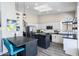 Bright kitchen with white cabinets, stainless steel appliances, island, and skylight at 9032 E Larkspur Dr, Scottsdale, AZ 85260
