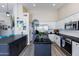 Open concept kitchen with white cabinets, a kitchen island, and a view into the house at 9032 E Larkspur Dr, Scottsdale, AZ 85260