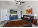 Living room with a TV, dark furniture, and a ceiling fan at 9032 E Larkspur Dr, Scottsdale, AZ 85260