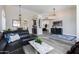 Open-concept living room with a cozy seating area, stylish furnishings and wood-look floors at 9032 E Larkspur Dr, Scottsdale, AZ 85260