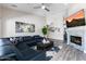 Comfortable living room with a large sectional sofa, fireplace, and modern decor at 9032 E Larkspur Dr, Scottsdale, AZ 85260