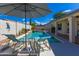 Outdoor living is easy around this pool, with shady seating, desert landscaping, and an expansive pool at 9032 E Larkspur Dr, Scottsdale, AZ 85260