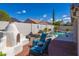 Relaxing pool with outdoor fireplace, lounge chairs, and easy access to the house at 9032 E Larkspur Dr, Scottsdale, AZ 85260