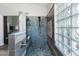 Beautiful stone shower with glass block window and built-in bench at 9032 E Larkspur Dr, Scottsdale, AZ 85260