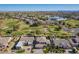 An aerial view of a home with a golf course in the background at 9363 E Mendoza Ave, Mesa, AZ 85209