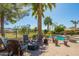 Beautiful patio area with comfortable seating and a view of the pool and lush landscaping at 9363 E Mendoza Ave, Mesa, AZ 85209