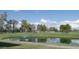 Picturesque golf course view with a serene pond and fountain feature at 9363 E Mendoza Ave, Mesa, AZ 85209