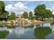 Beautiful lake with a rock water fall and trees reflecting in the water at 9363 E Mendoza Ave, Mesa, AZ 85209