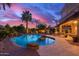 Sparkling swimming pool surrounded by lush landscaping and a comfortable patio area at 9363 E Mendoza Ave, Mesa, AZ 85209