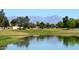 Picturesque pond on the golf course, reflecting the surrounding trees and mountains at 9363 E Mendoza Ave, Mesa, AZ 85209