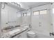 This bright bathroom features a granite vanity top and a shower-tub combination at 9631 E Palm Ridge Dr, Scottsdale, AZ 85260