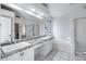 Spacious bathroom featuring double sinks, granite countertops, glass block window, and a separate tub and shower at 9631 E Palm Ridge Dr, Scottsdale, AZ 85260