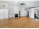 Bright living room with fireplace, hardwood flooring, and open access to the kitchen for easy entertaining at 9631 E Palm Ridge Dr, Scottsdale, AZ 85260