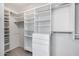 Custom walk-in closet with ample shelving and storage space for clothing, shoes, and accessories at 9631 E Palm Ridge Dr, Scottsdale, AZ 85260