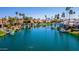 Scenic aerial view of waterfront homes along a canal with palm trees and boat docks at 10421 N 100Th St, Scottsdale, AZ 85258