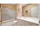 Clean bathroom with a combined shower and tub with glass doors, toilet, and sink at 10421 N 100Th St, Scottsdale, AZ 85258