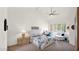 Bright bedroom with a ceiling fan, white walls, and shutters at 10421 N 100Th St, Scottsdale, AZ 85258