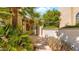 House entrance featuring desert landscaping, tall palms and a tiled walkway at 10421 N 100Th St, Scottsdale, AZ 85258