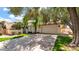 This home's exterior features an inviting driveway, mature trees, and a two-car garage for parking at 10421 N 100Th St, Scottsdale, AZ 85258