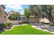 Single-Gathering home boasts lush green lawn, mature trees, and a spacious driveway leading to the two-car garage at 10421 N 100Th St, Scottsdale, AZ 85258