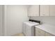 Clean laundry room with a washing machine, dryer, and white cabinets at 10421 N 100Th St, Scottsdale, AZ 85258