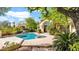 Backyard pool and spa surrounded by lush greenery, perfect for relaxation at 10421 N 100Th St, Scottsdale, AZ 85258