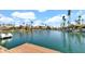 Waterfront community view featuring a boat and stunning homes on a sunny day at 10421 N 100Th St, Scottsdale, AZ 85258