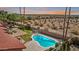 Aerial view of the backyard, pool, desert landscape, and colorful sunset at 10563 E Bella Vista Dr, Scottsdale, AZ 85258