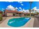 The backyard features a pool, grassy area, covered patio and desert landscaping at 10563 E Bella Vista Dr, Scottsdale, AZ 85258