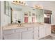 Bathroom featuring a marble vanity top and double sinks and a large mirror at 10563 E Bella Vista Dr, Scottsdale, AZ 85258