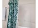 Bathroom featuring a green and white floral shower curtain and coordinating hand towel at 10563 E Bella Vista Dr, Scottsdale, AZ 85258