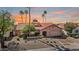 Charming single-story home featuring a tile roof, desert landscaping, and a two-car garage at 10563 E Bella Vista Dr, Scottsdale, AZ 85258