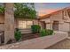 Inviting front entrance featuring a decorative door, manicured landscaping, and covered porch at 10563 E Bella Vista Dr, Scottsdale, AZ 85258