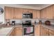 Kitchen with light wood cabinets, stainless steel appliances, and tile backsplash at 10563 E Bella Vista Dr, Scottsdale, AZ 85258