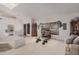 Comfortable living room featuring a skylight, vaulted ceilings, and a seamless flow into the dining area at 10563 E Bella Vista Dr, Scottsdale, AZ 85258