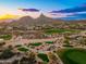 Breathtaking aerial view of golf course community with mountain views at sunset at 10707 E Cottontail Ln, Scottsdale, AZ 85255