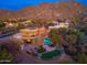 Luxury desert home boasts a pool, spa, putting green, and lush landscaping with majestic mountain backdrop at 10707 E Cottontail Ln, Scottsdale, AZ 85255