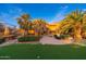 Expansive backyard with lush greenery, featuring a pool, putting green, and outdoor seating, perfect for leisure and entertainment at 10707 E Cottontail Ln, Scottsdale, AZ 85255