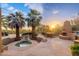 Backyard with an outdoor fireplace, BBQ, patio dining and a hot tub with waterfall at 10707 E Cottontail Ln, Scottsdale, AZ 85255