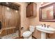 Bathroom featuring a glass door shower, a vanity, toilet, and medicine cabinet at 10707 E Cottontail Ln, Scottsdale, AZ 85255