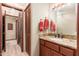 Bathroom featuring granite counters and custom cabinets, with neutral tile flooring at 10707 E Cottontail Ln, Scottsdale, AZ 85255